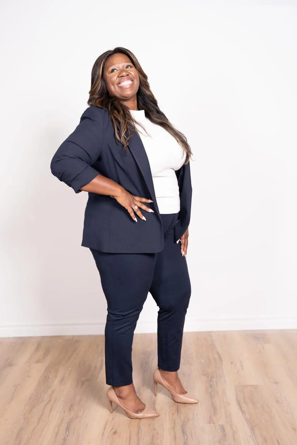 Nadea Clarke, candidate for Regional and City Councillor in Ward 1, Oshawa, standing in a navy suit.